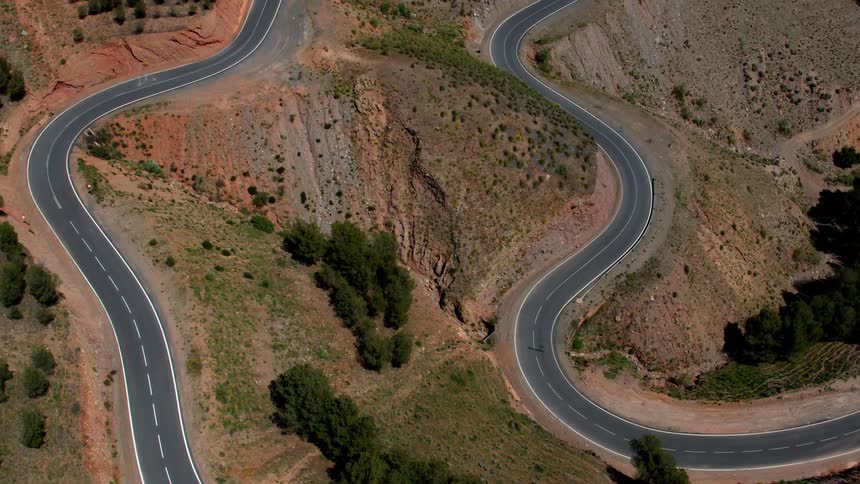 A mountain road curves and winds as it climbs up the Sierra Nevada mountain range
