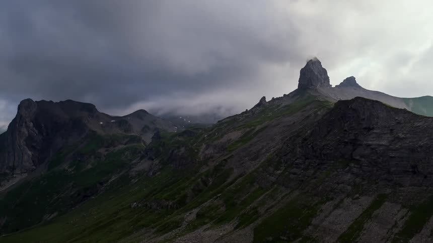 Dark clouds hang above the mountains