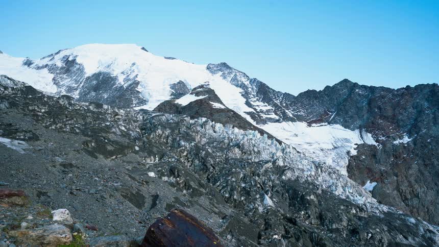 A snow covered rocky mountain time lapse