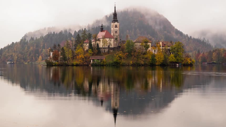 Tiny island with a church is perfectly reflected in Bled lake in Slovenia