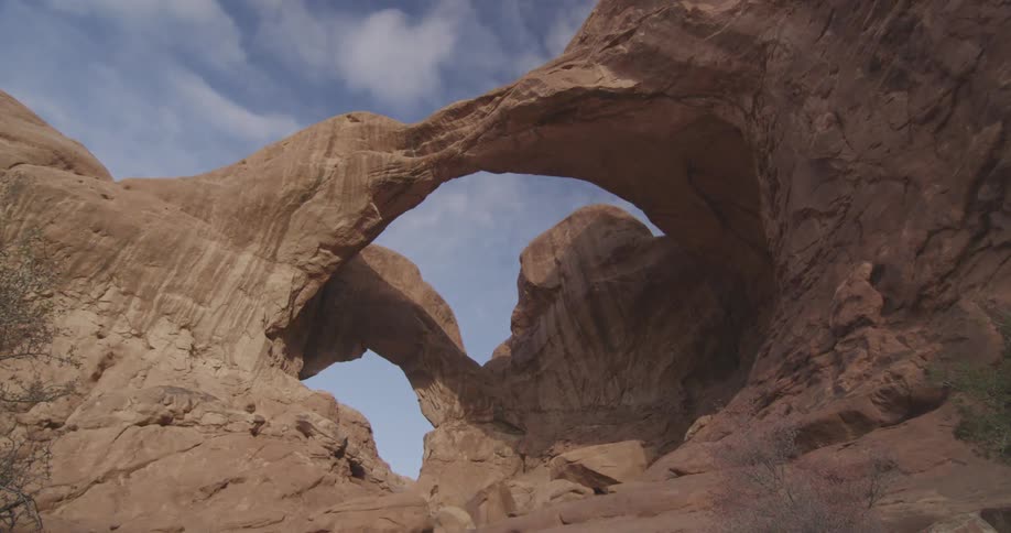 Clouds float over a rock arch