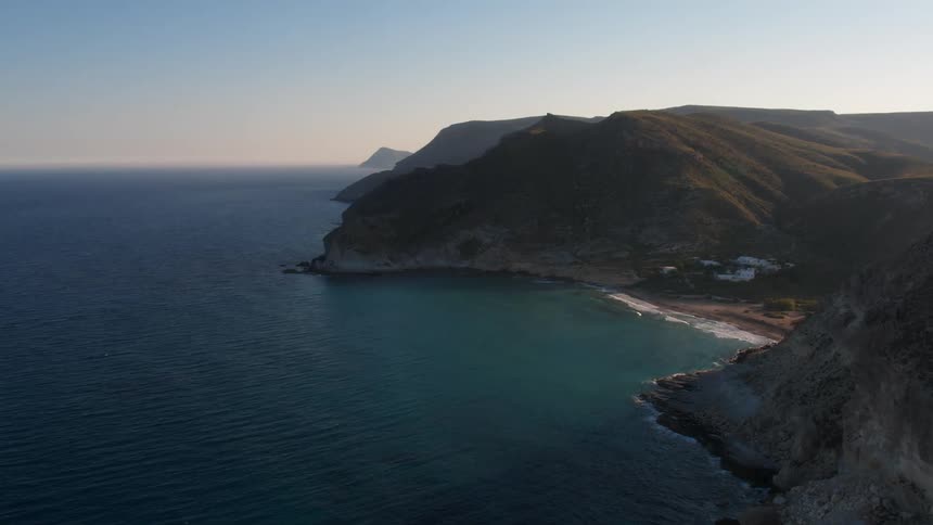 The calm, blue Mediterranean sea rolls towards the shore