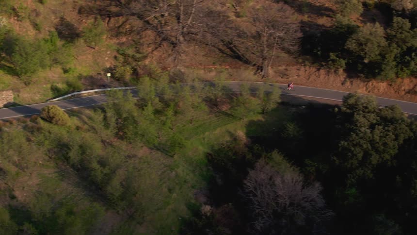 A person is riding their bike on the small mountain road in the south of Spain