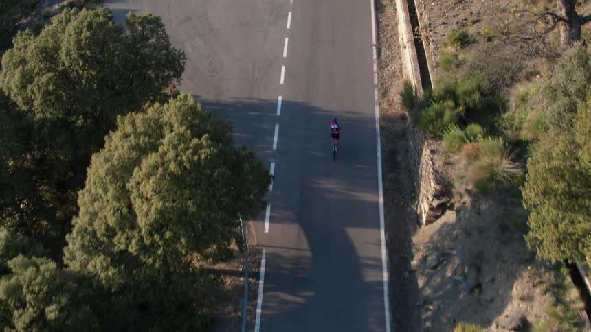 A bicyclist rides down a mountain road in Andalucia