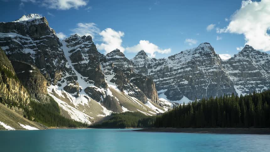 The Five Sister mountain peaks covered with snow and ice surround Moraine lake in Banff