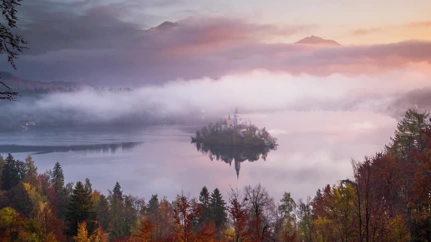 The clouds roll right over the church on the small island of Bled, Slovenia