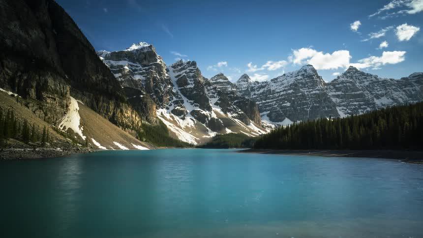 Water moves in Lake Moraine by the majestic Rocky Mountains in Banff