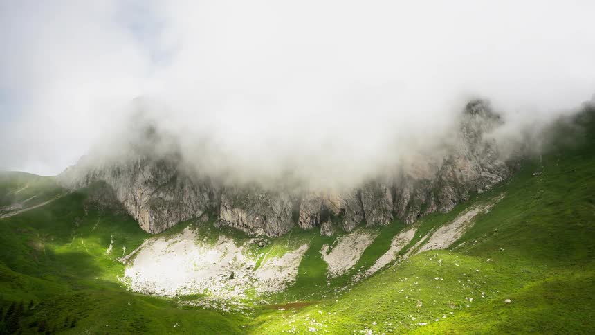 Fog and haze lift above a mountain valley