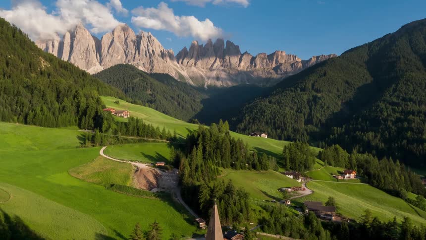 There are houses on the hills between these mountains