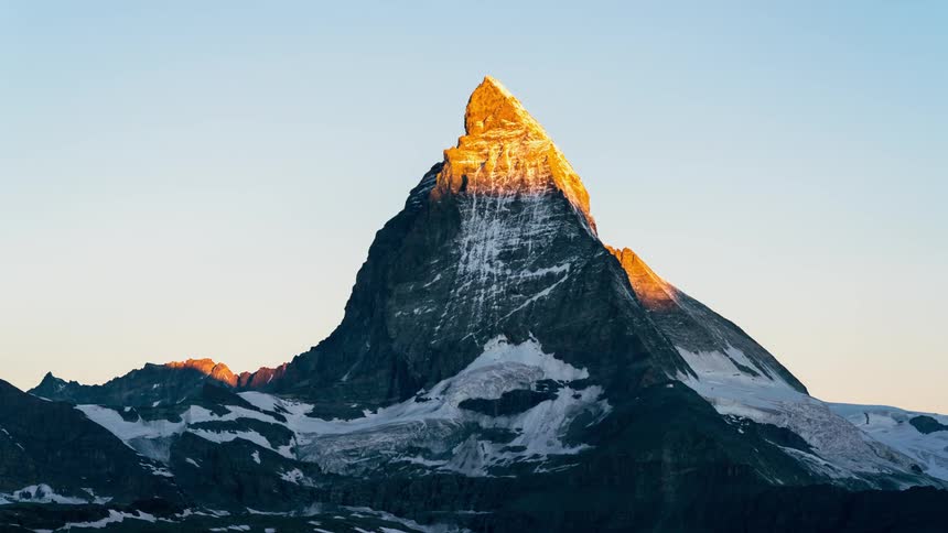 Sun rising over the majestic mountain peak of Matterhorn