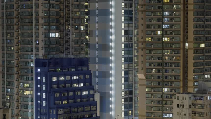 Apartment building lights turn on and off in the evening