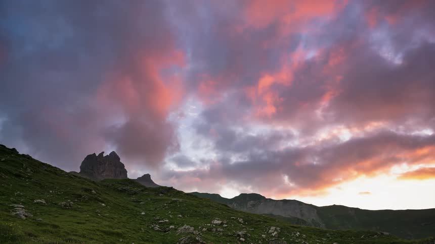 Colorful clouds move across the sky then clear