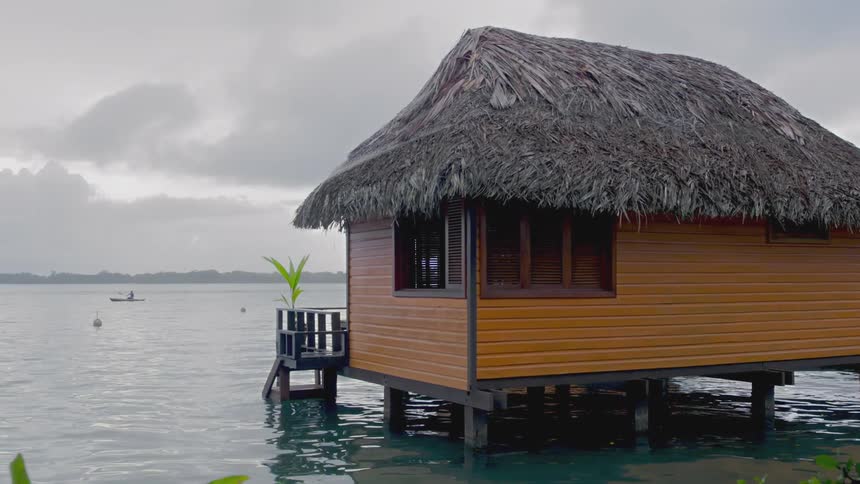 Stilt house over water on a cloudy day