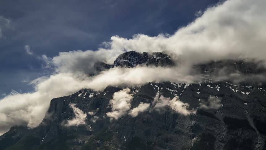 Clouds swirl around the Tunnel mountain top in Banff National Park, Canada