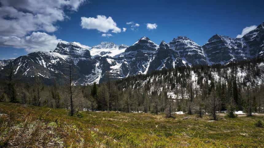 The tall mountains line the green Larch valley below in Banff National Park, Canada