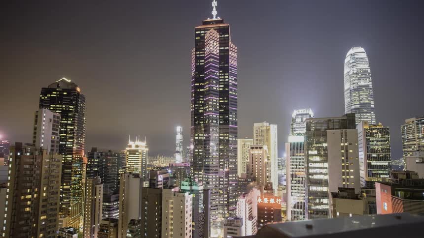 The tall buildings have flashing lights all over