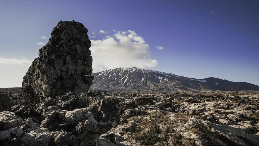 Clouds are drifting across a mountain on a sunny day