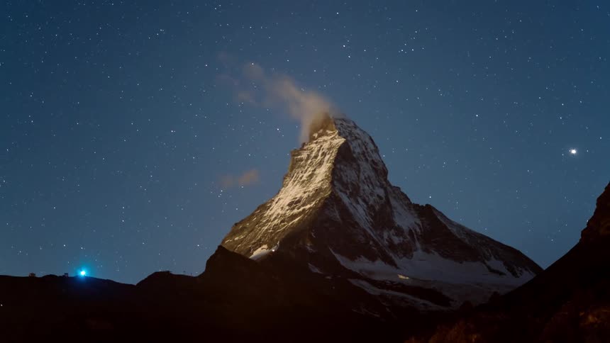 Steam lifts off the mountain top at night