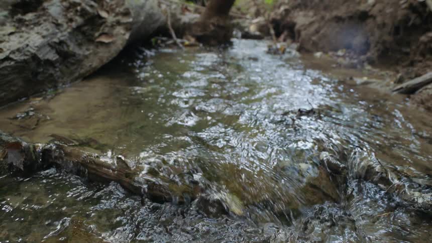 Water flowing over brown rock