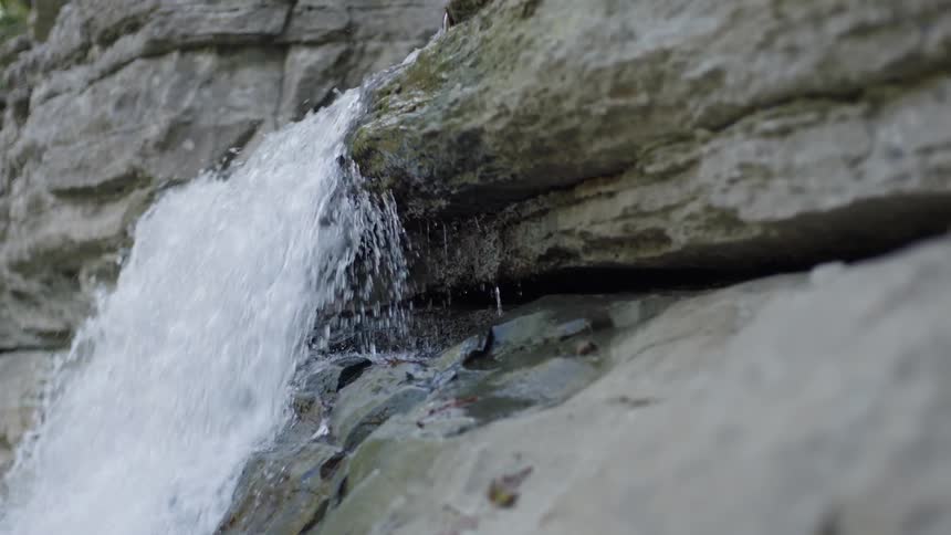 Water is falling down the side of a rock