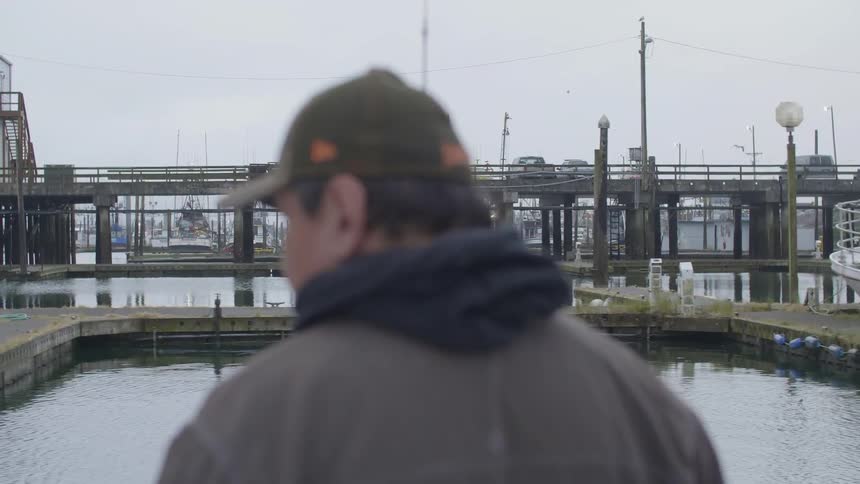 Man rides on a boat in a marina