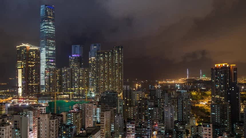 Time lapse of the city lights and clouds at night