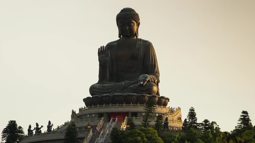 A buddhist monument is displayed atop a set of stairs