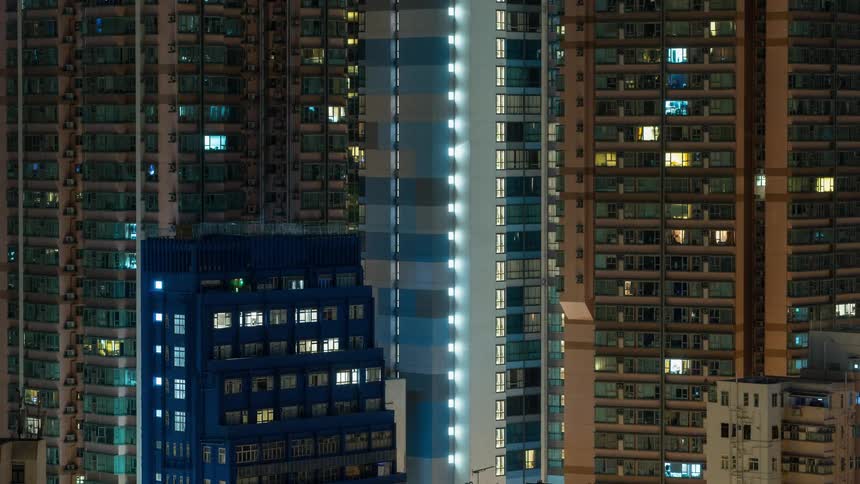 Lights turn on and off inside skyscrapers as the night passes