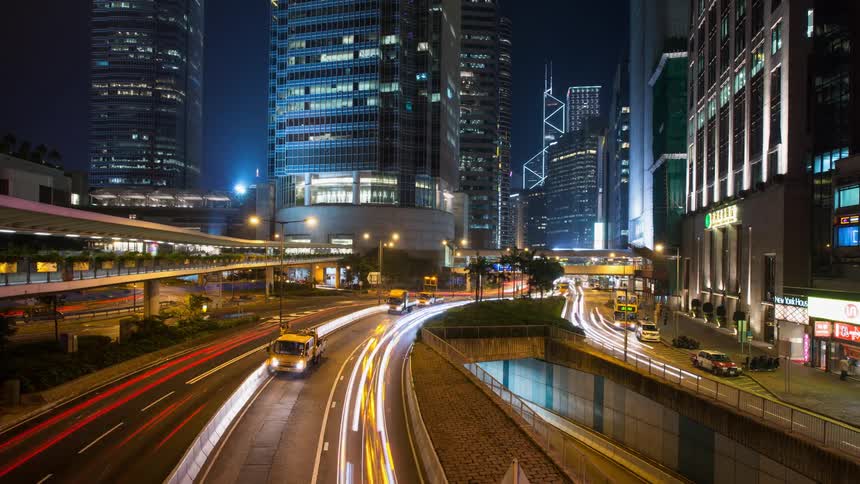 Time-lapse of the highway running through a city at night