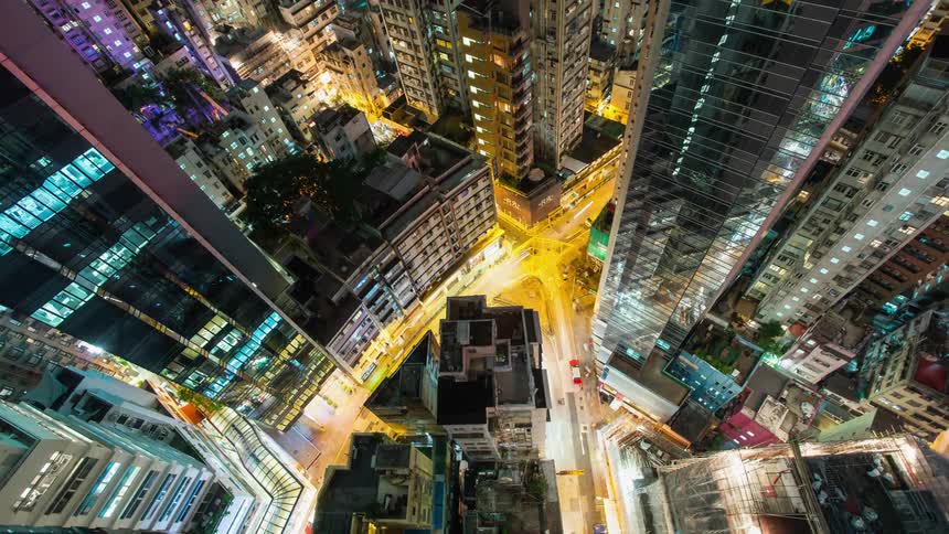 Time lapse of a busy city at night filmed from a rooftop