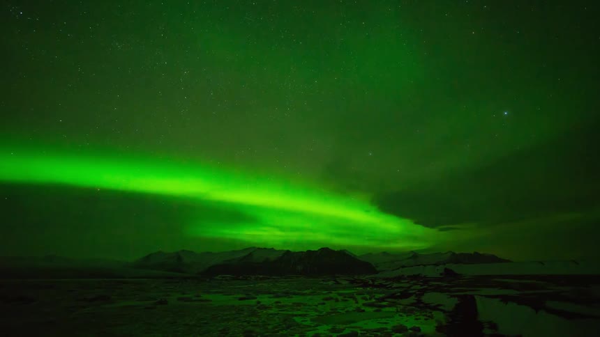 Northern lights swirl around the sky