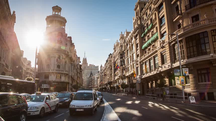 Cars stop and go as they travel in the city