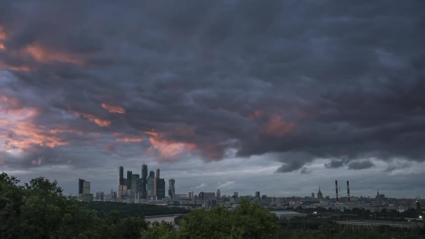 Storm clouds are moving across the city of Moscow at dusk