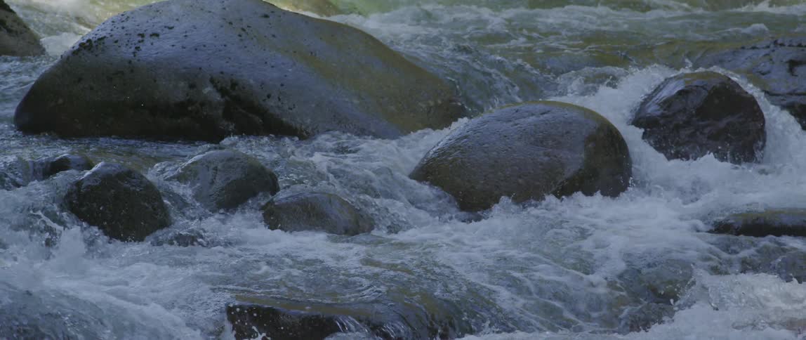 Water crashing around boulders