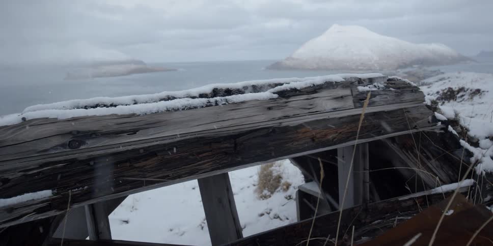 An old wooden structure covered in snow