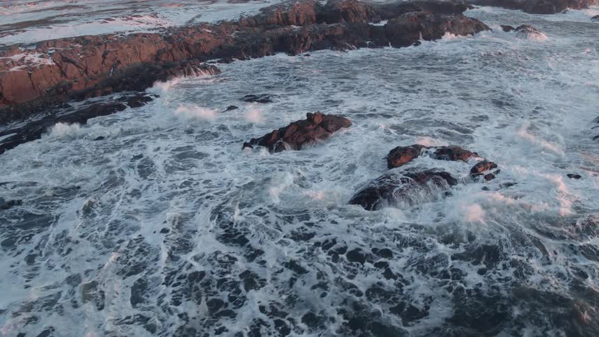 Waves crash onto the rocky shore