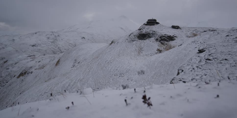 A frozen hillside with an old bunker