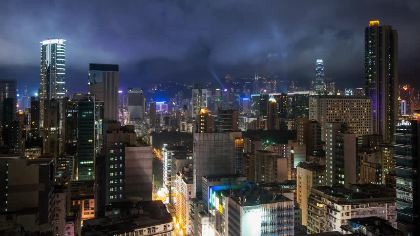 Time lapse of city lights reflecting on the clouds above