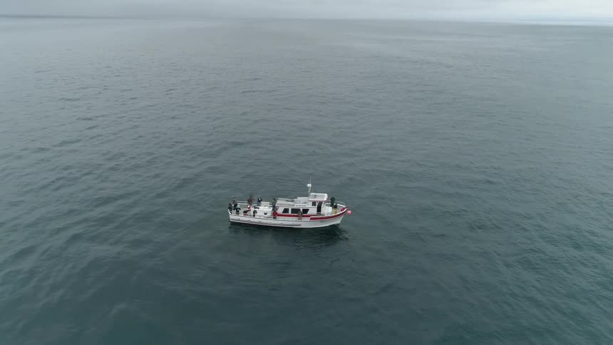A boat is sitting in a calm ocean