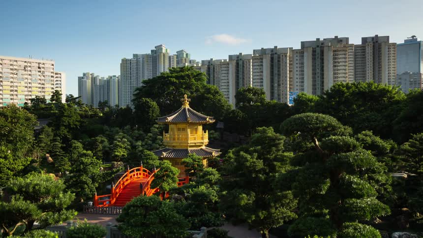 Small temple surrounded by park and skyscrapers in Hong Kong