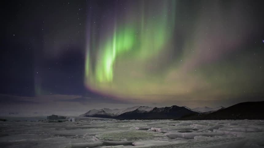 Time lapse of the aurora over a body of frozen water
