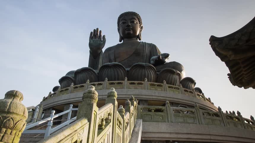 A buddhist monument is displayed atop a set of stairs