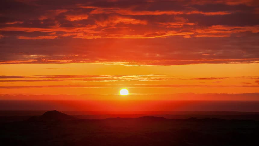 The sun sets over the horizon