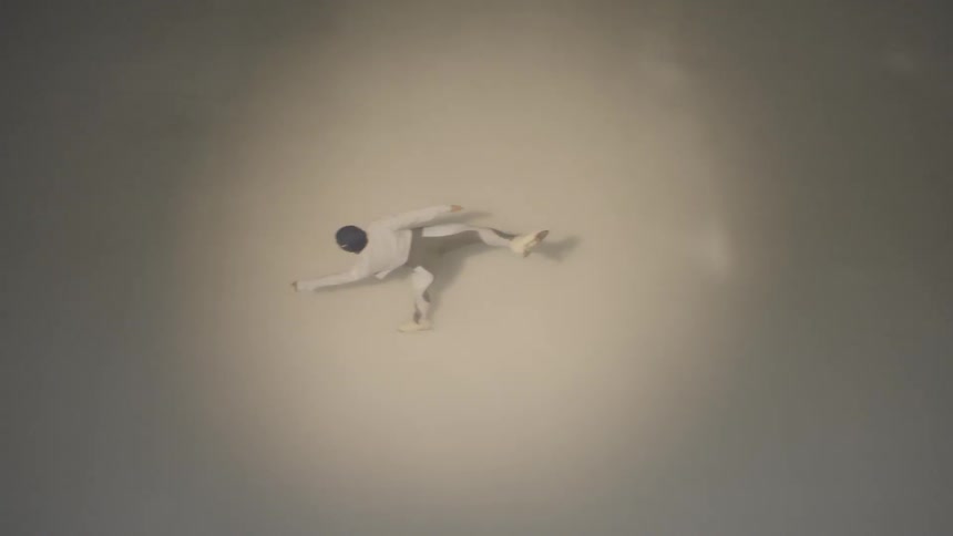 An ice skater is gliding across the ice