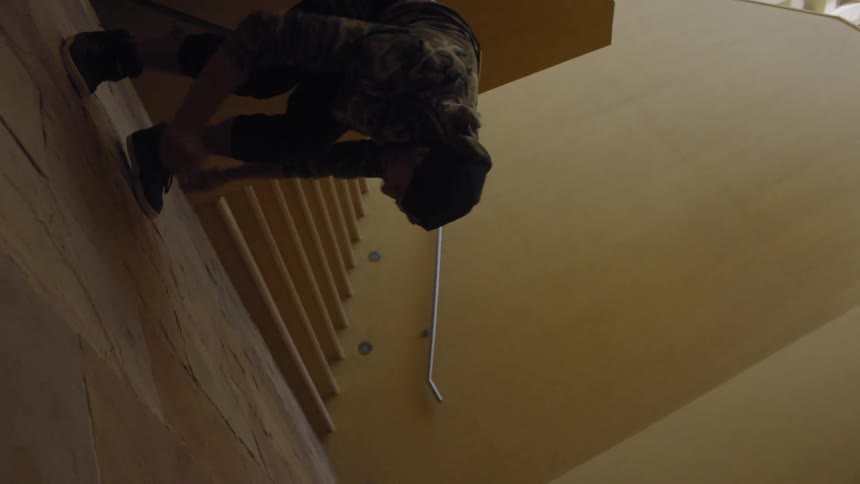 A man flips off the wall and runs up the steps