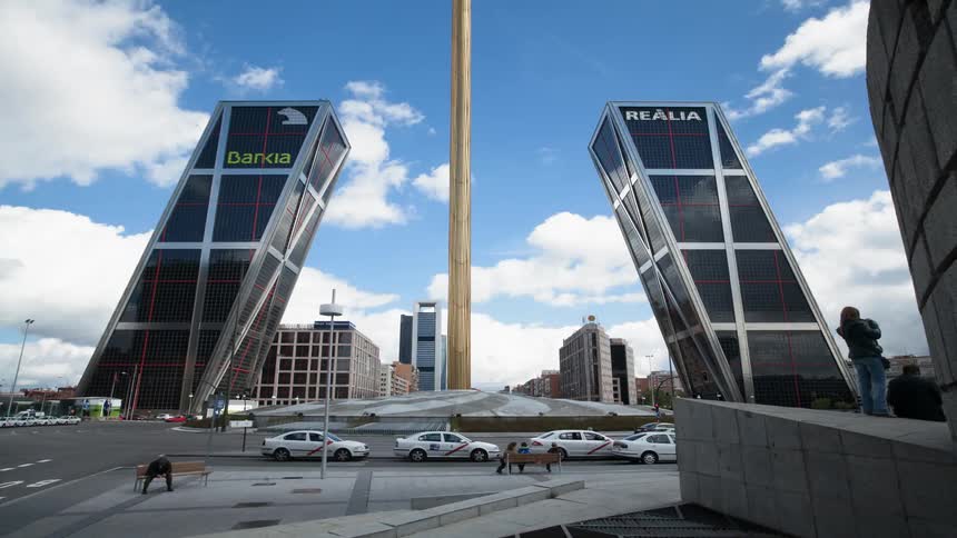 Pedestrians and cars commute in a city