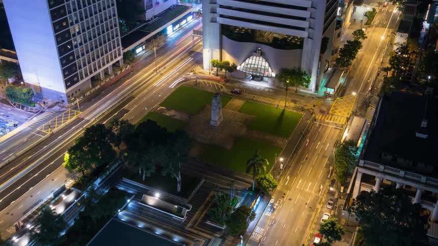 Vehicles pass by on a city street at night