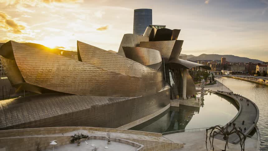 Tourists visit a city attraction at sunset