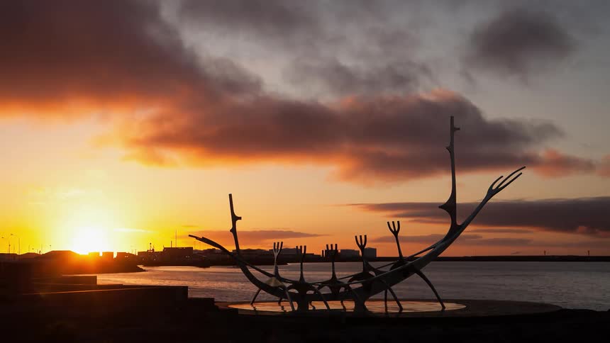 Time lapse of a sculpture on a lake as the sun sets