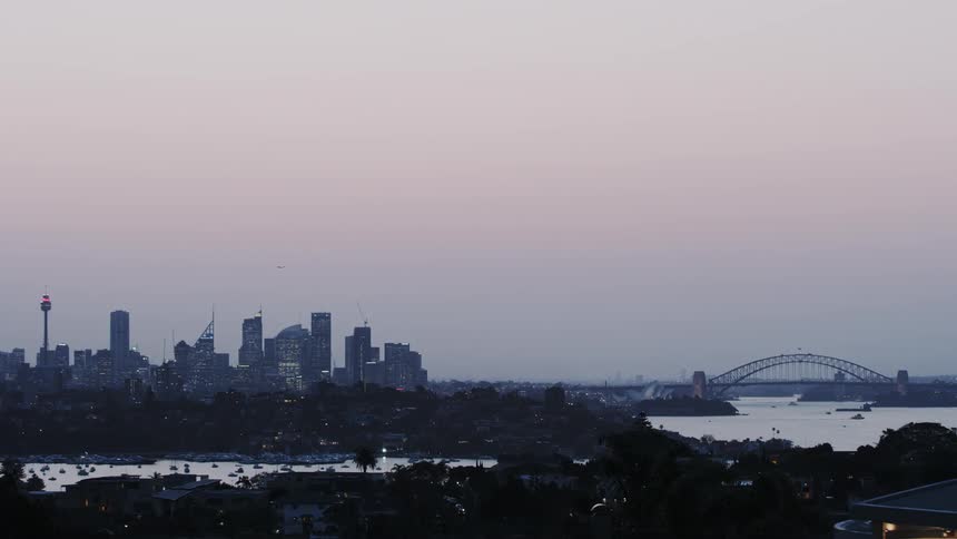 A cityscape is shown at dusk